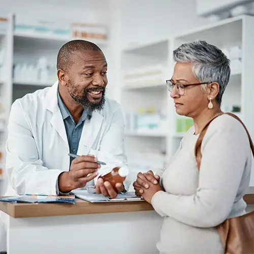 Pharmacist consulting with patient